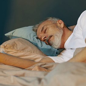 Senior man sleeping peacefully on his side