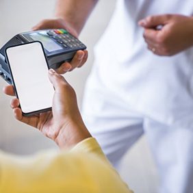 Person using phone to pay for treatment