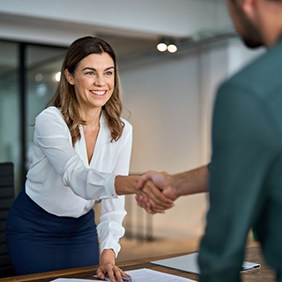 Businesswoman shaking hands in office setting