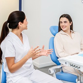 Patient and dental team member talking during appointment