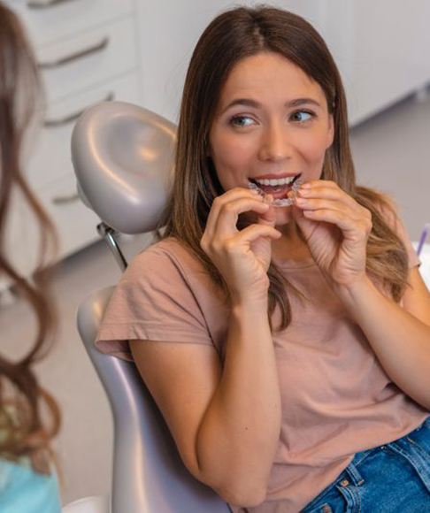 Young woman trying her clear aligner in dental office