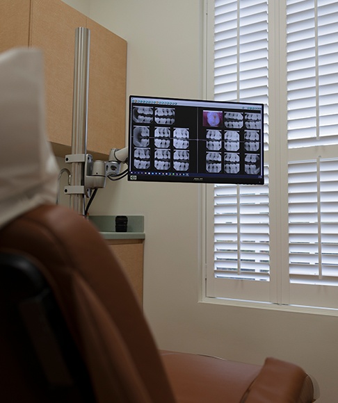 Dentist and patient reviewing digital 2 D and 3 D dental images