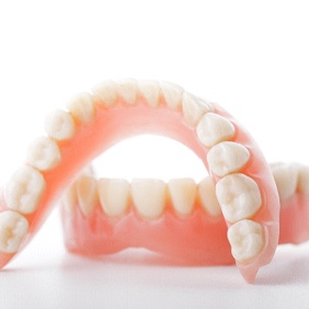 Closeup of full dentures in Vero Beach on white background