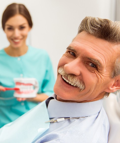 a patient smiling after getting dentures in Vero Beach