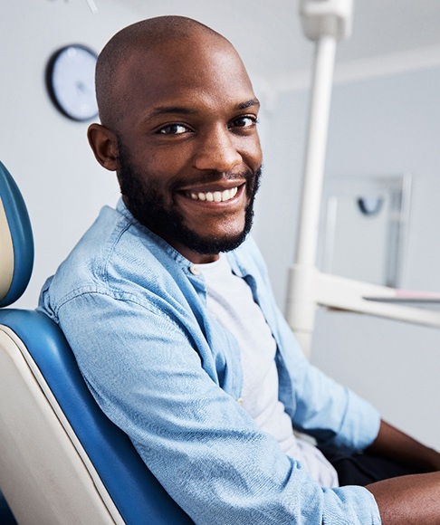 Bearded man in dental chair smiling