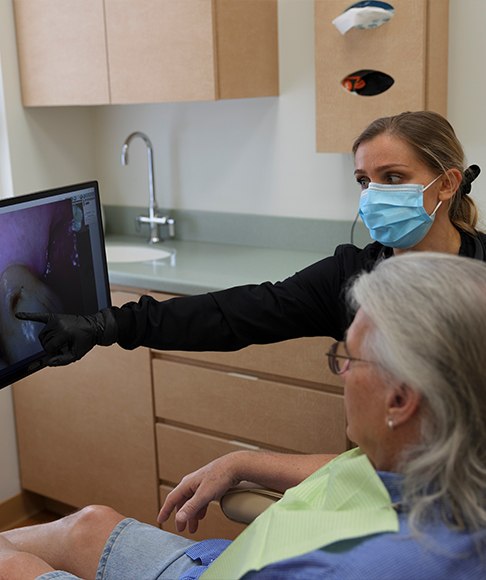Dentist and patient reviewing treatment options for common dental emergencies