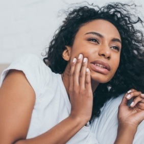 Woman with toothache holding cheek