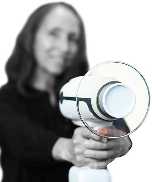 Dental team member holding up electric toothbrush that can help prevent dental emergencies