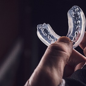 Athlete holding a mouthguard