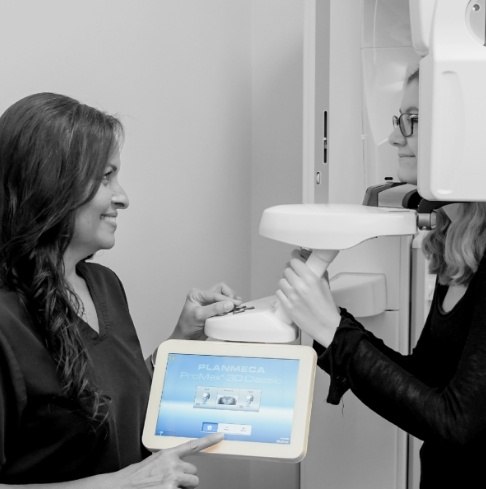 Dental team members using 3 D C T digital scanner in Vero Beach