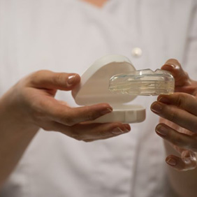 Dental team member holding a mouthguard