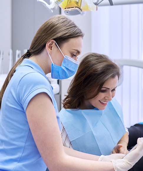 Patient and dental team member looking at tablet