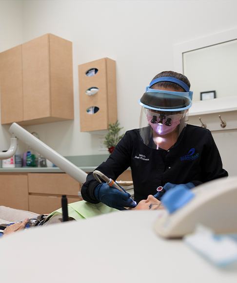 Woman smiling after dental cleaning