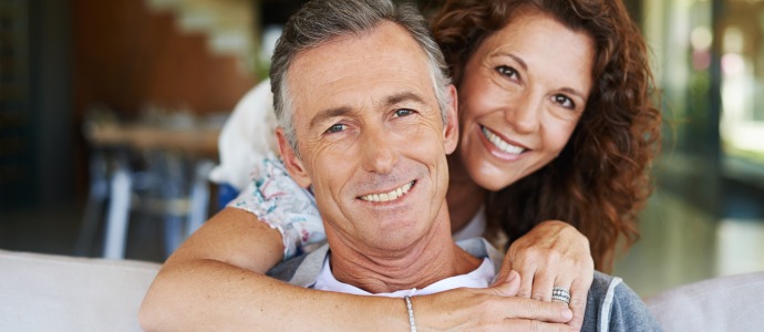 Man and woman sharing healthy smiles after preventive dentistry