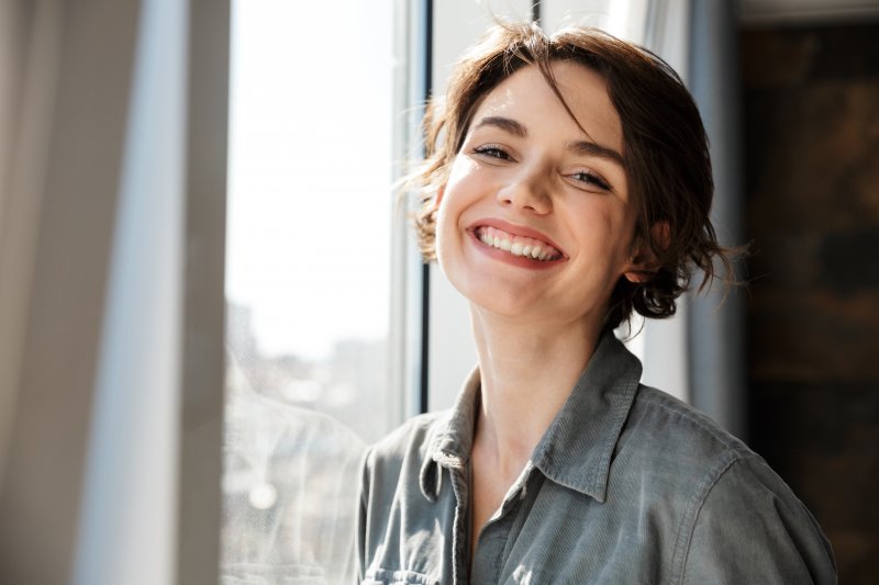 person with a dental bridge smiling