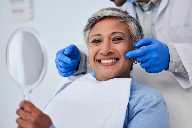 middle-aged woman smiling in the dentist’s chair