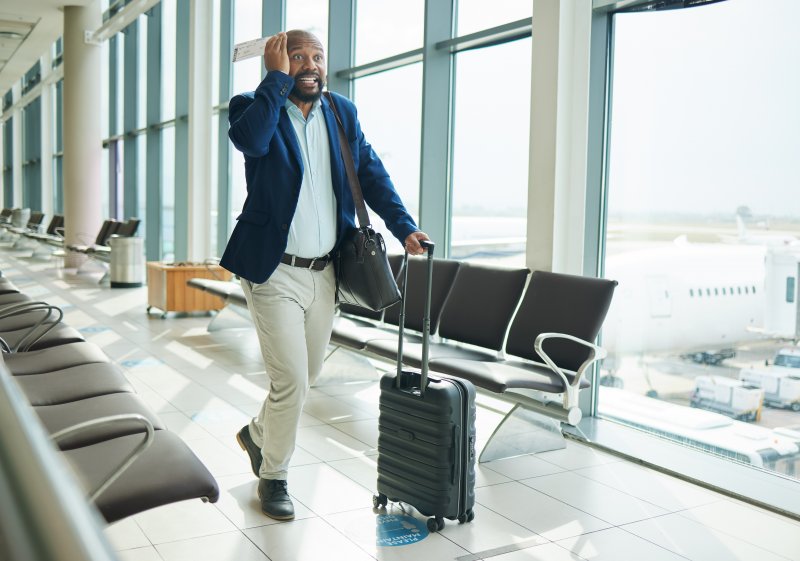 A man trying to get to his plane after receiving dental implants