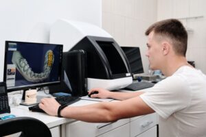 Dental lab technician working on computer 