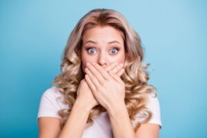 Shocked woman covering her mouth with her hands 