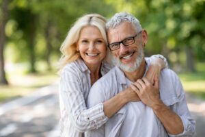 Smiling senior couple embracing outdoors