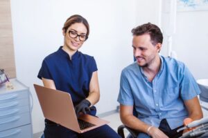 Dentist and patient looking at computer